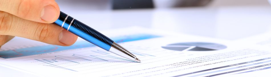 Image of a person writing in a workbook. 